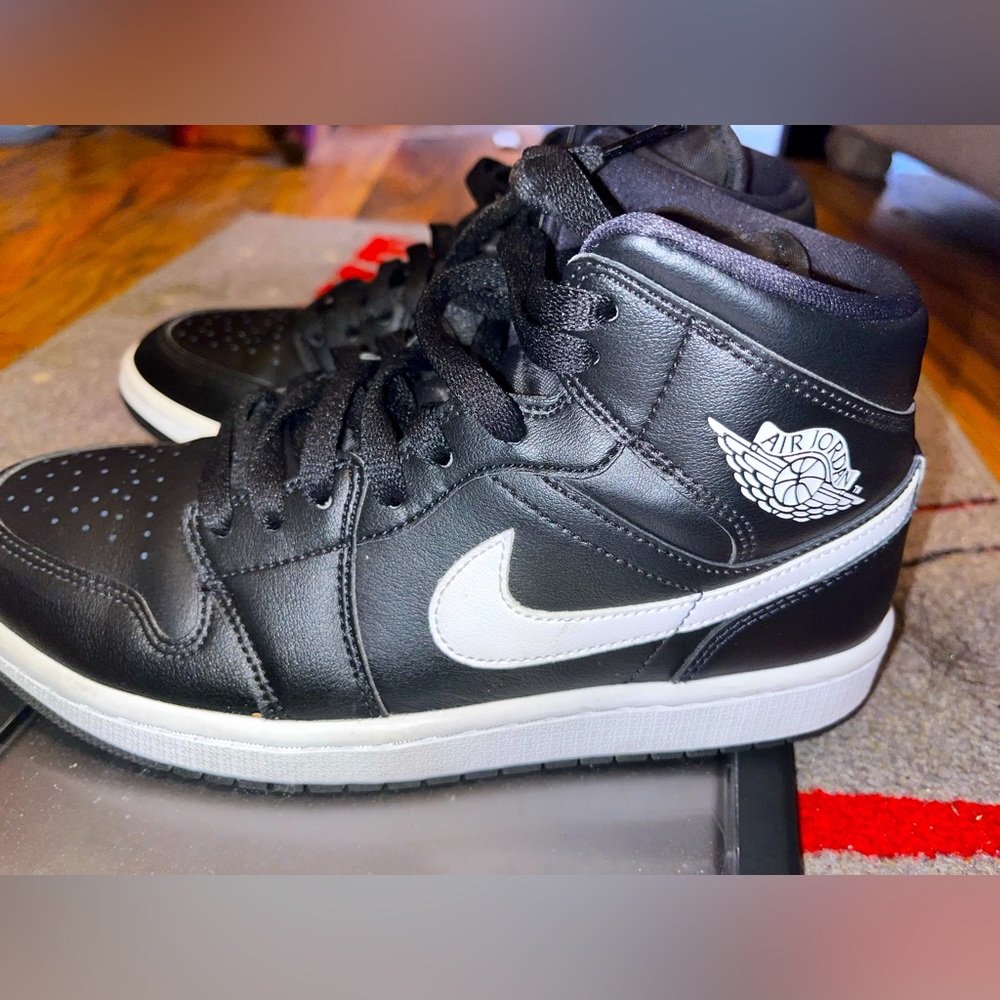 Black size 8 women’s Air Jordens. Mid rise